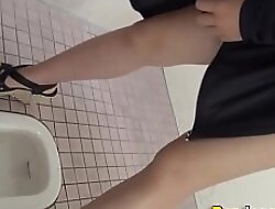 Squatting asians urinate in public toilet